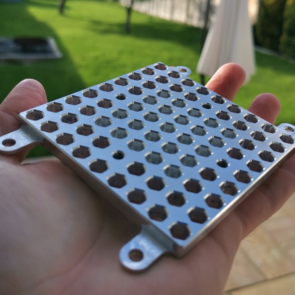 Aluminum part with a grid of holes
